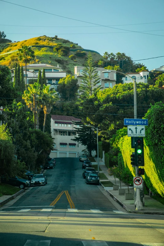 a street sign next to the road and some trees