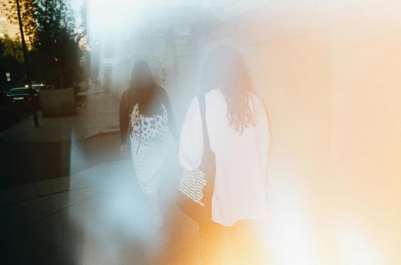 two dark haired women are walking together