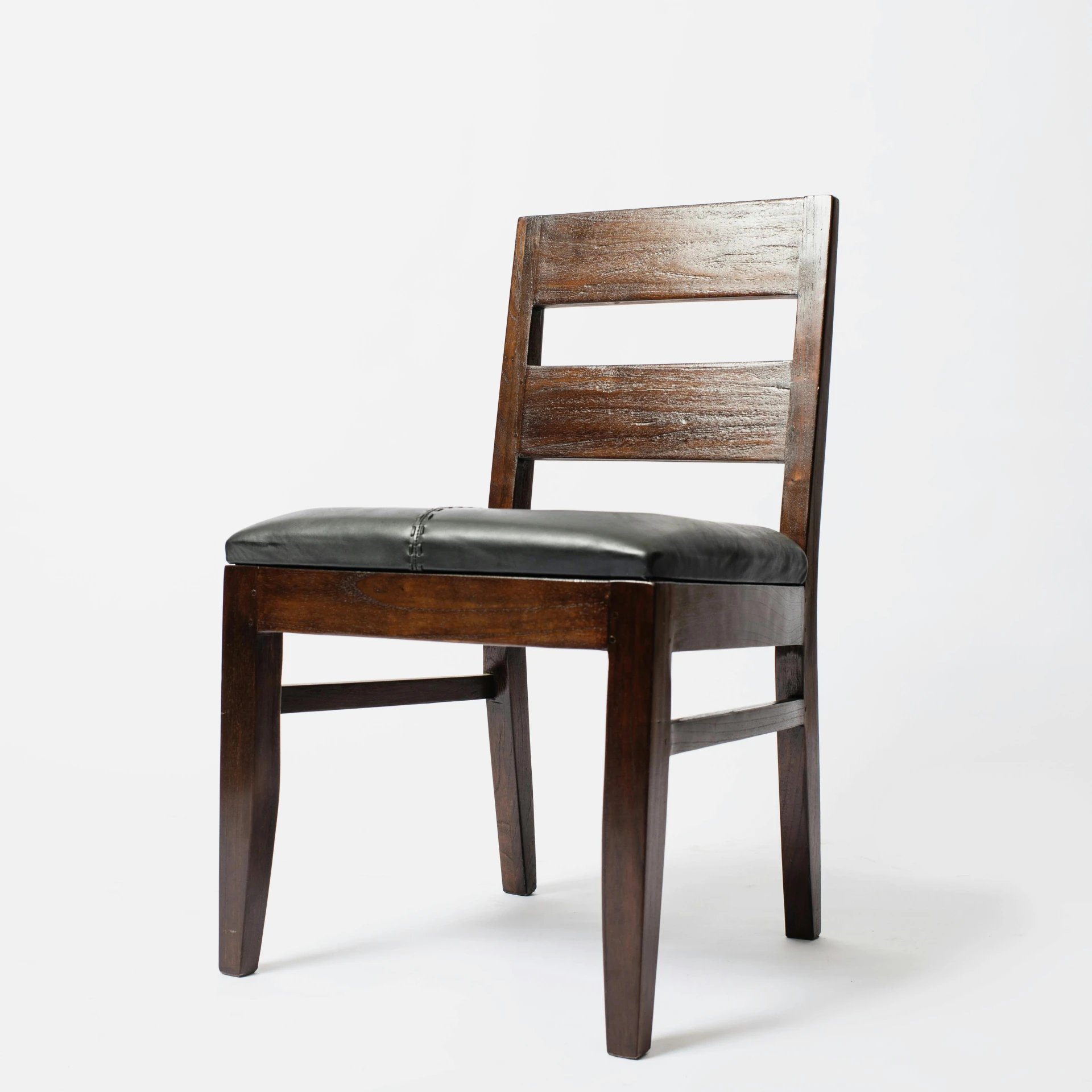 a chair with leather cushion sitting on a white surface