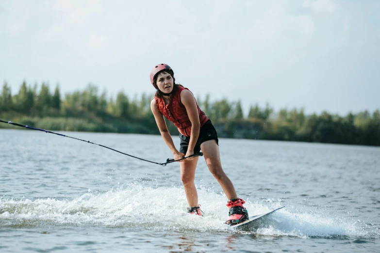 a woman skiing with a rope attached to her water board