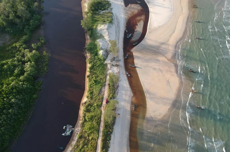 a bird's eye view of a beach and a waterway with boats