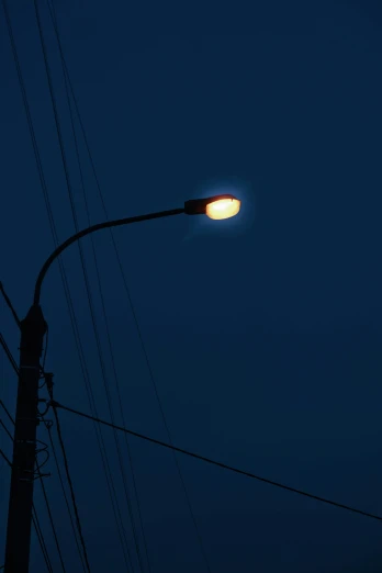 a street light sitting next to power lines