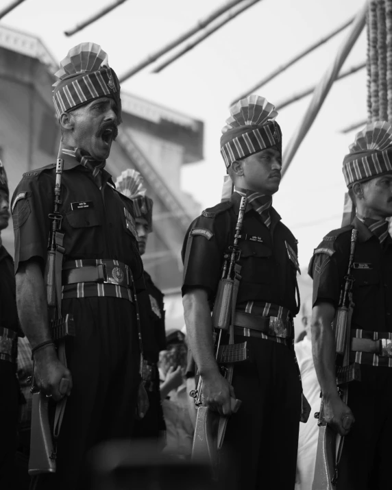 policemen wearing helmets standing next to each other