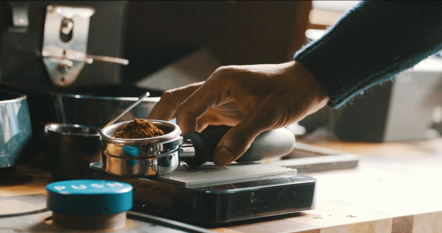 a person is putting the spices in a can on a stove