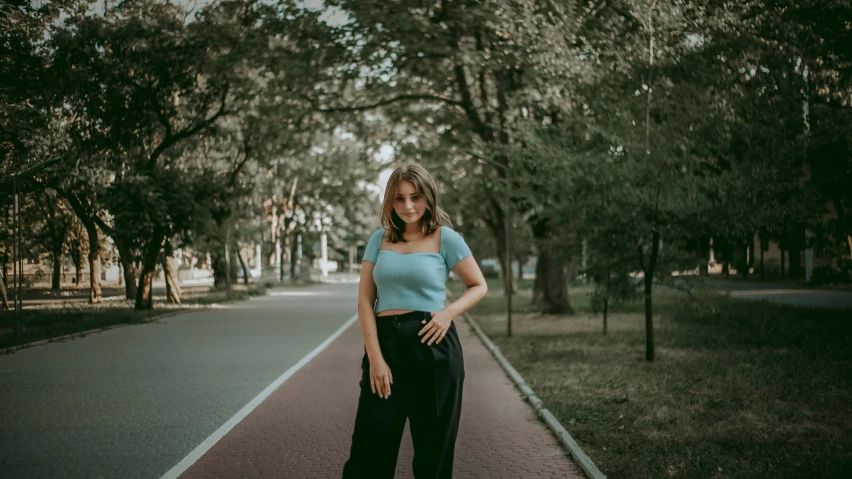 there is a woman that is standing on the road