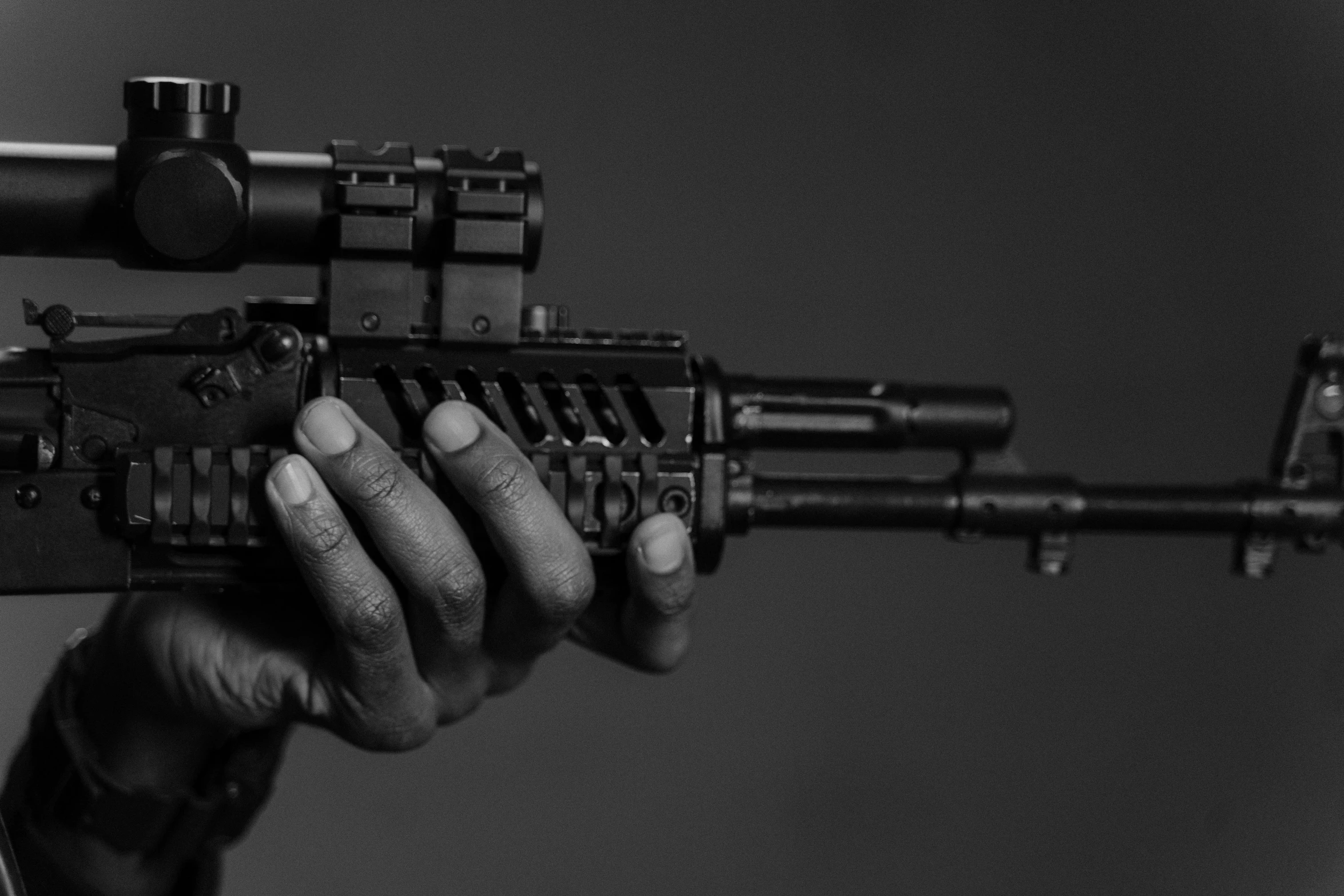 black and white image of a person holding a rifle