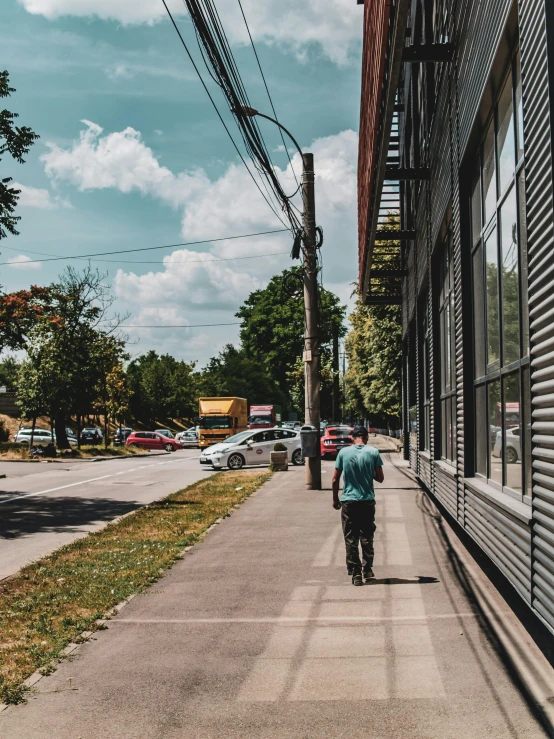 a person is walking down the street in front of a store