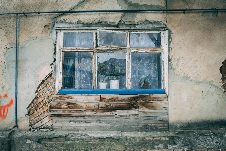 a window with a paint drip is shown near the graffiti