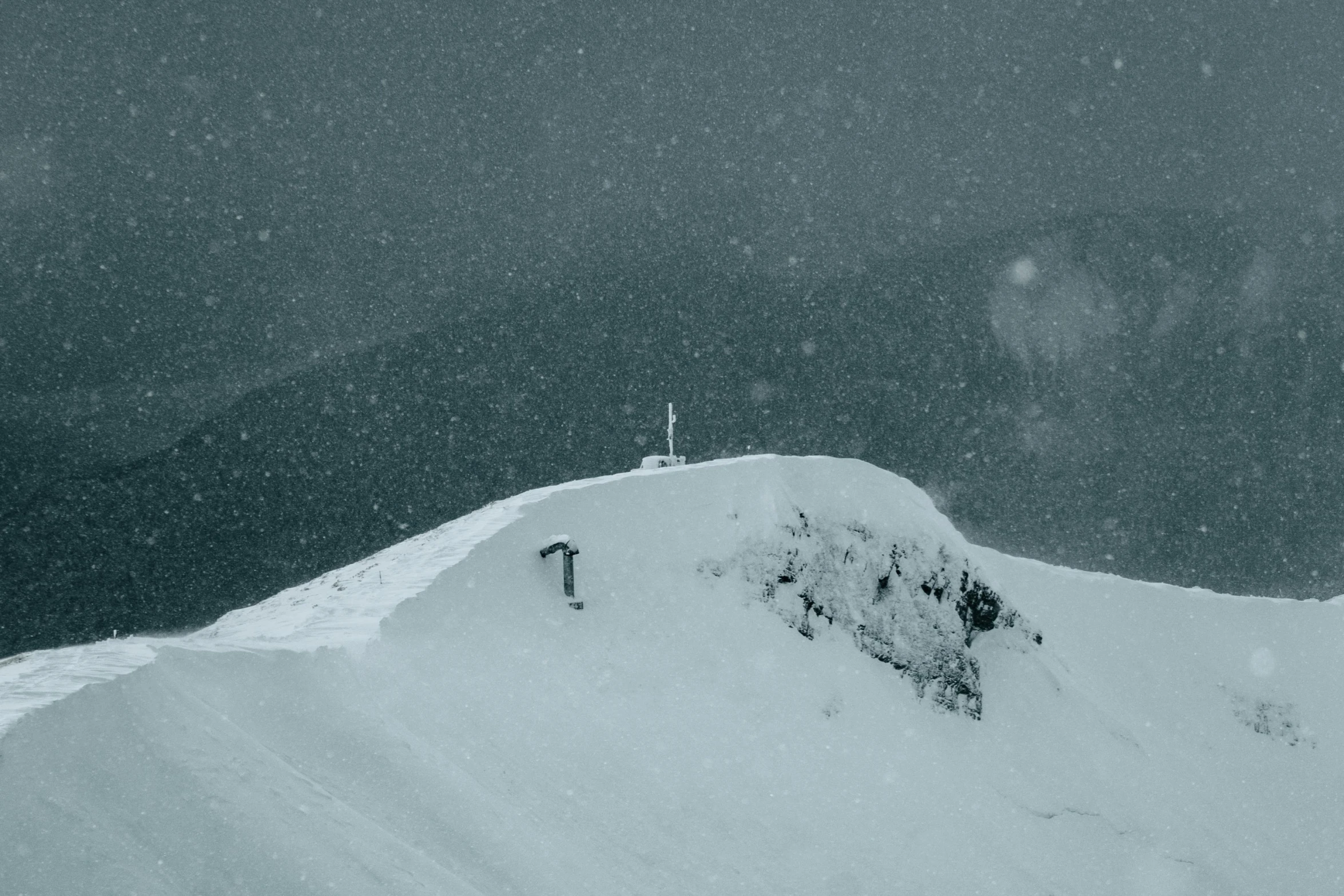 a man riding skis down the side of a snow covered slope