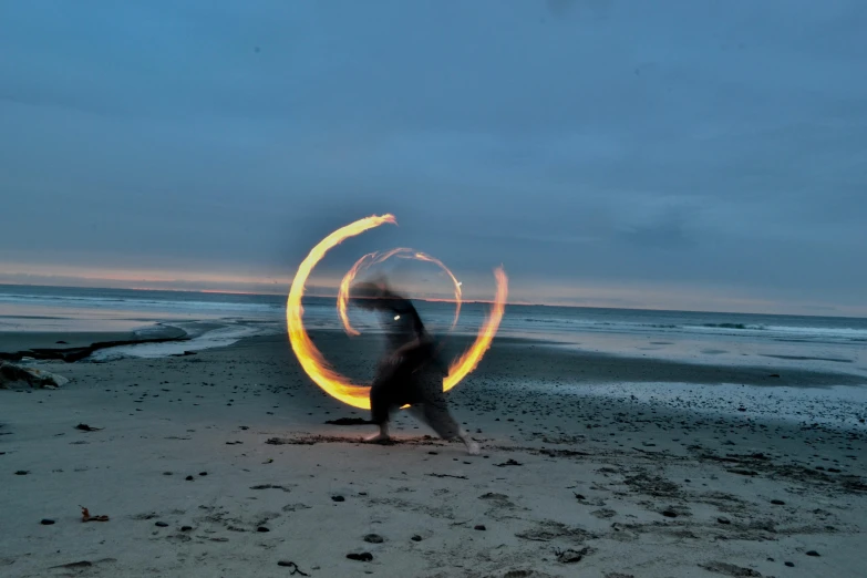 a person holding a ring with flames in their hands