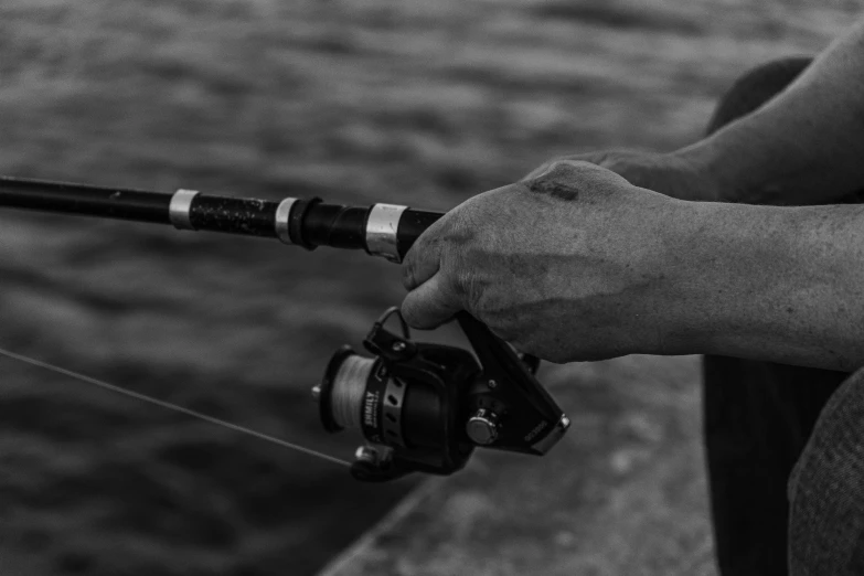 a person holding a fishing rod with a fish on it