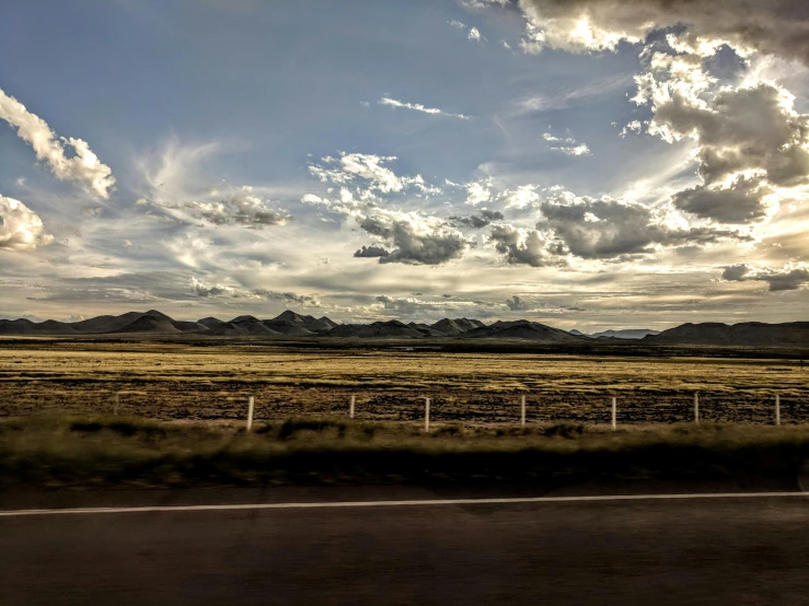 a wide open field with mountains in the distance