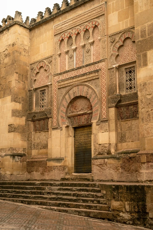 a building with ornate windows and steps up to it