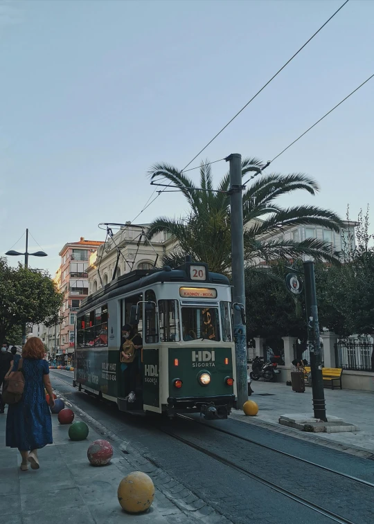 a trolley train is coming down the street