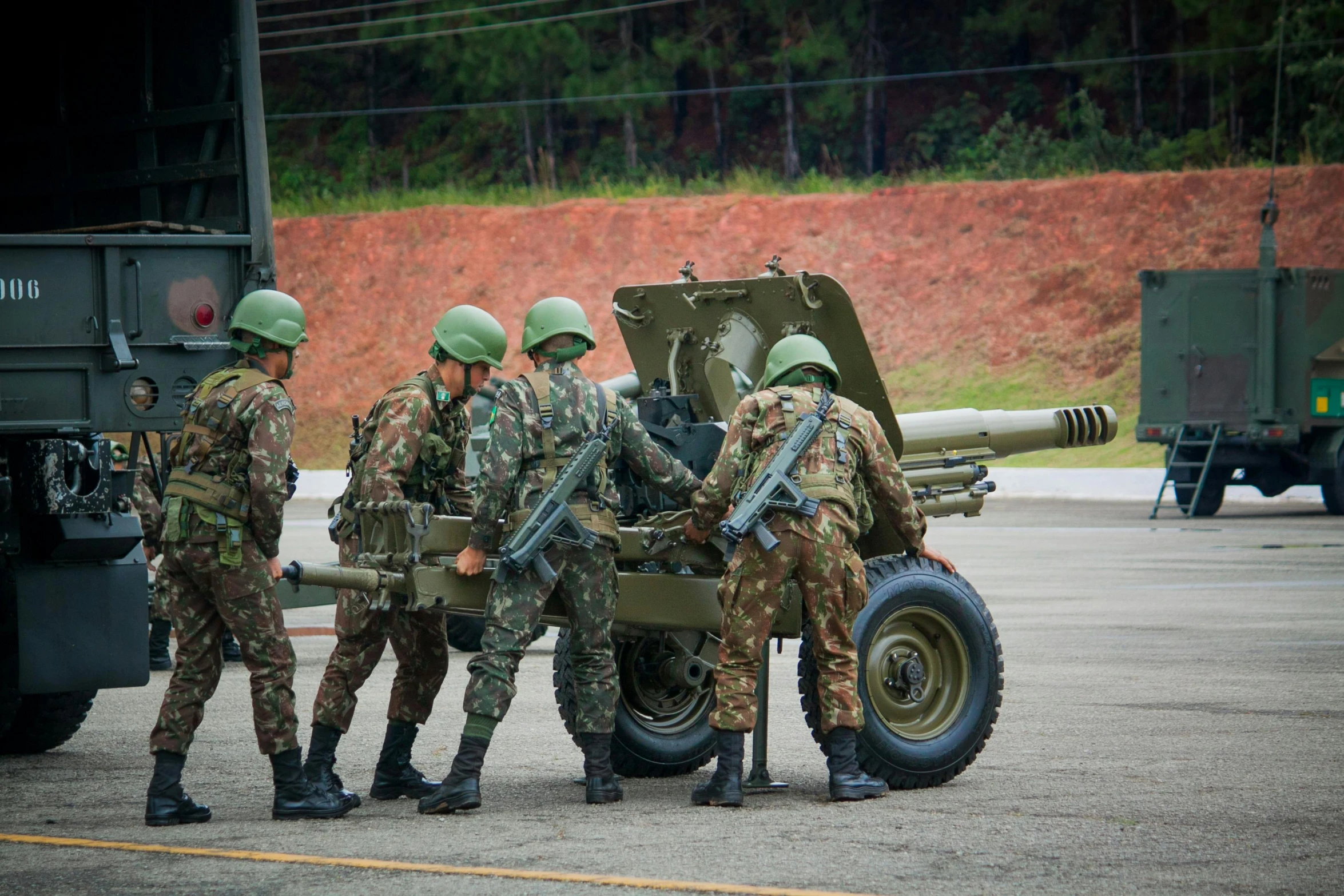 some soldiers are talking to one another with guns