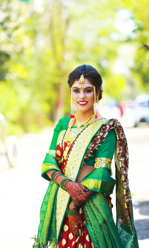 an indian bride with traditional dress poses for a portrait