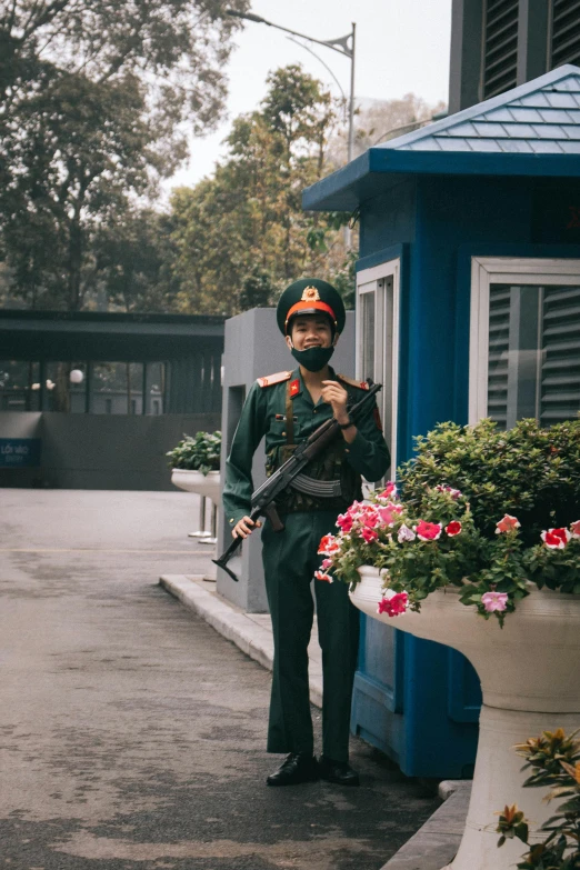 an indian man in a uniform holding his rifle