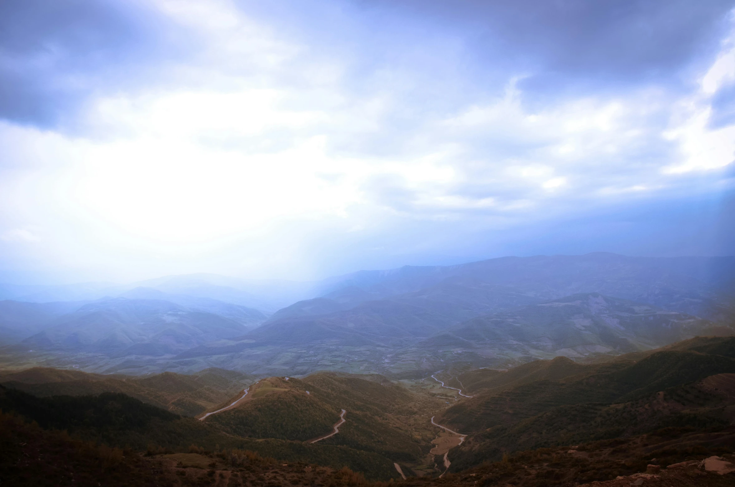 a mountain range with a road winding through it