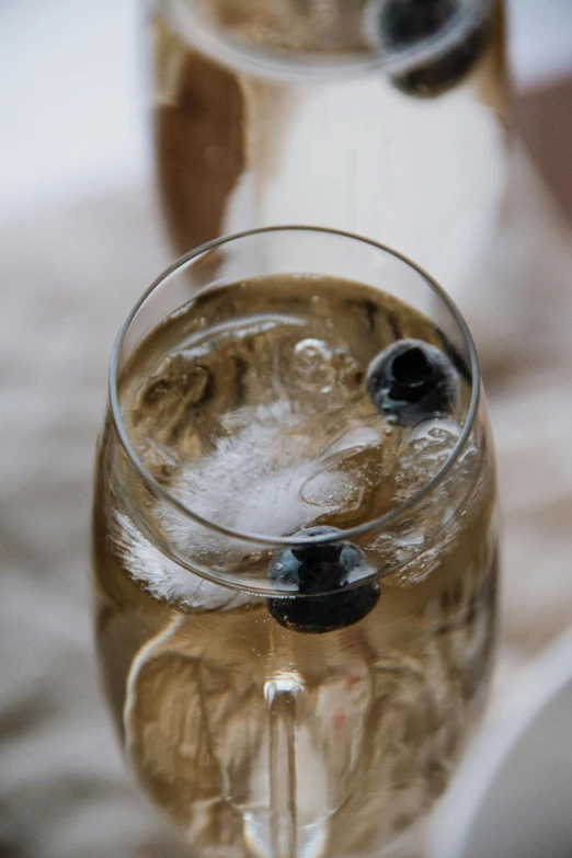 a wine glass has a drink on top and bubbles