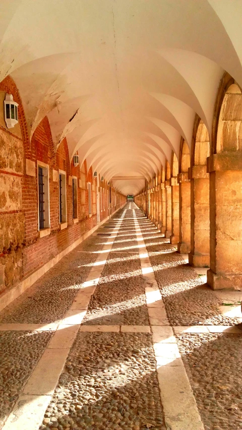 an alley with arches and windows lined up to one another