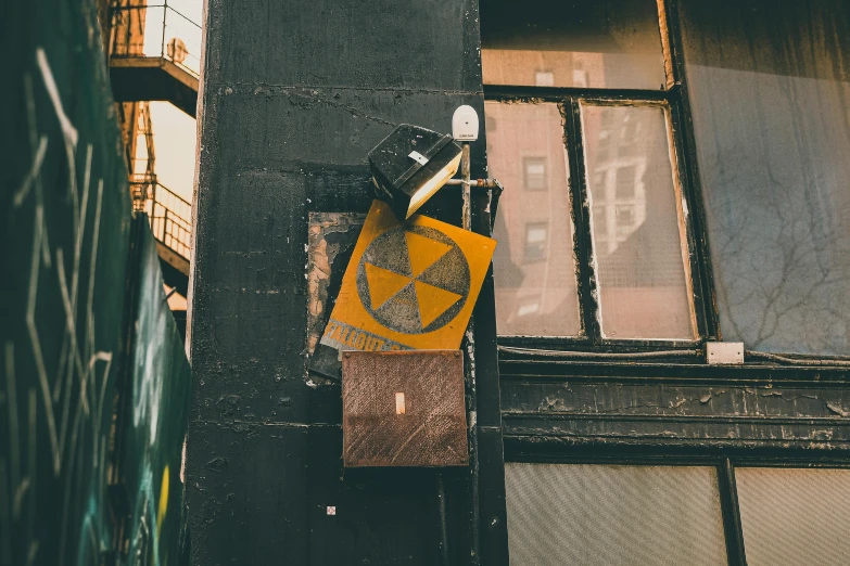 an alleyway sign with graffiti on it near an open door