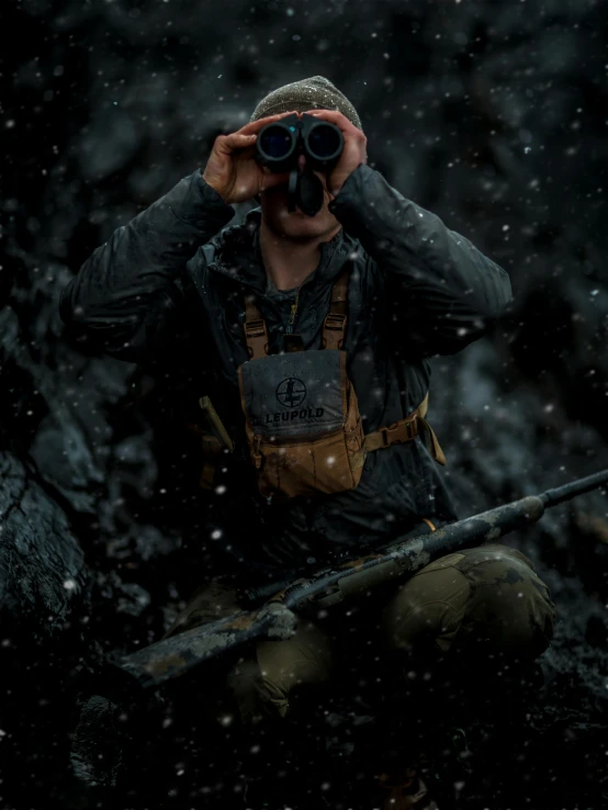 a man wearing overalls is holding a pair of binoculars and looking into the distance