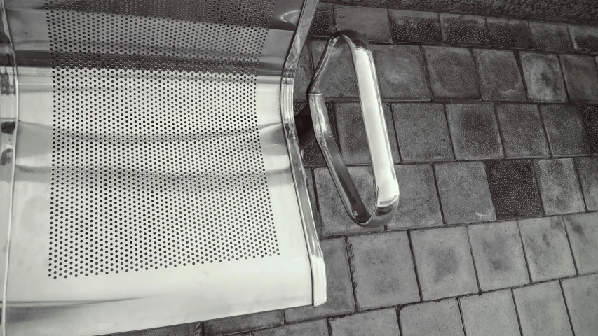 a seat with a handle sits on top of the ground