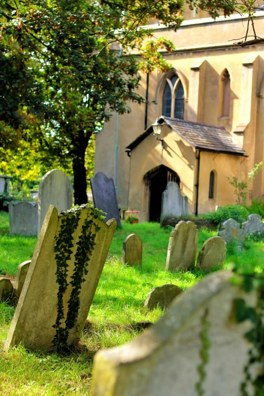 a group of headstones in front of a church