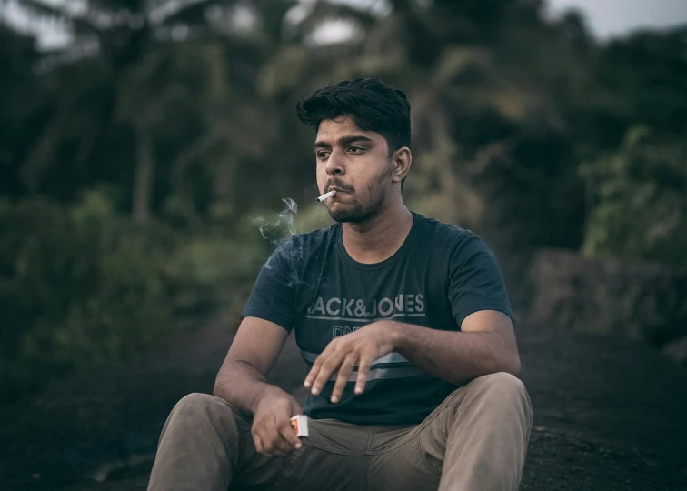 a man smokes an electronic cigarette outside