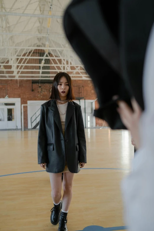 a person standing on a court in a gymnasium