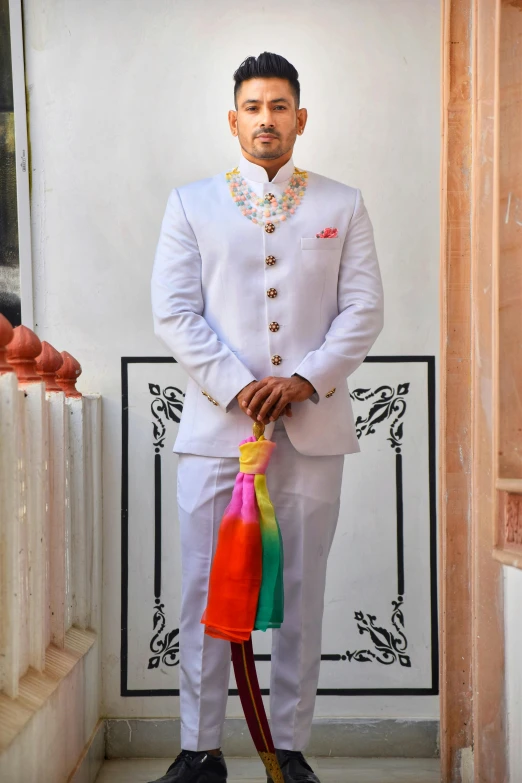 a young man dressed in indian clothing poses