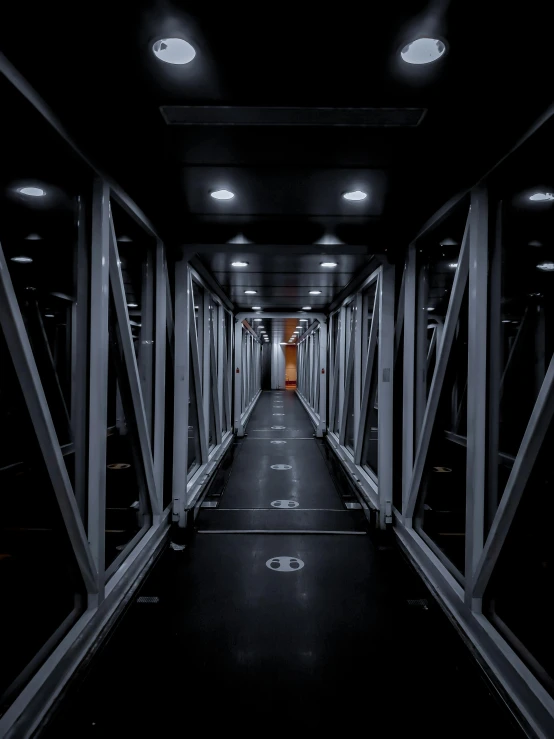 a long corridor in a building lit up with lights