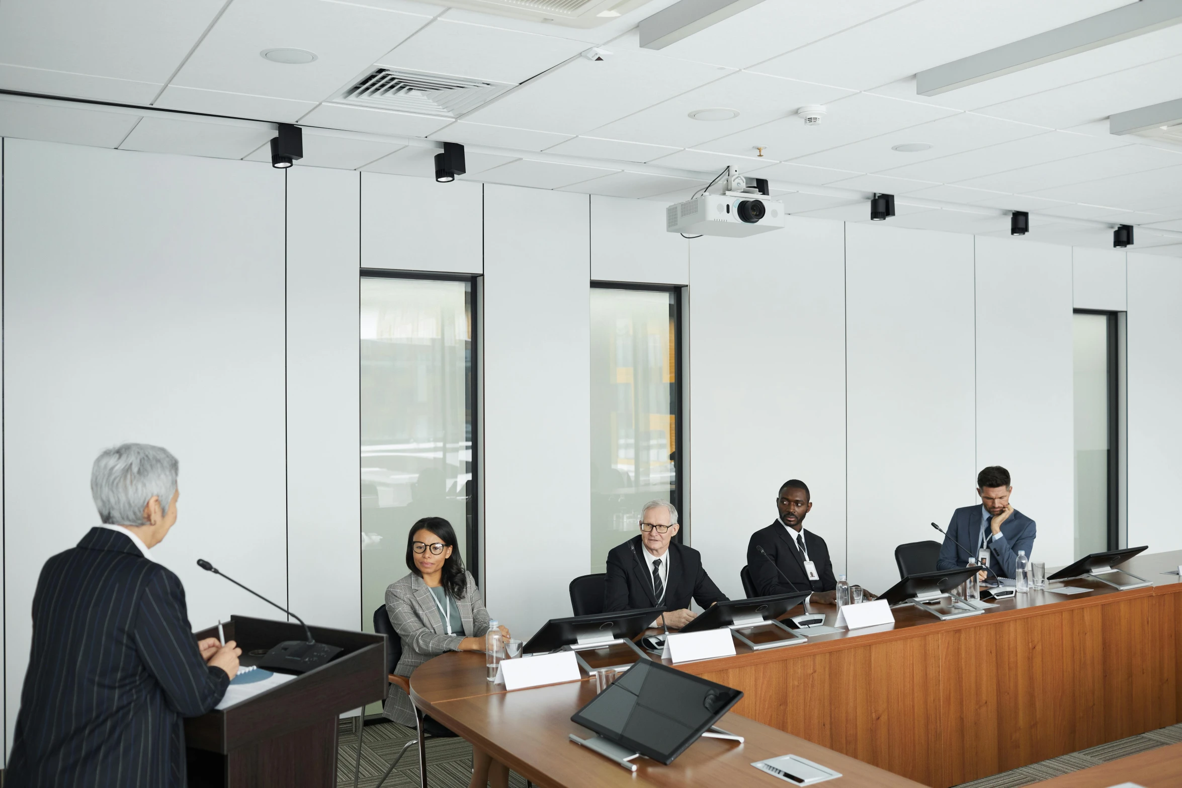 four people sitting around a table in a conference room