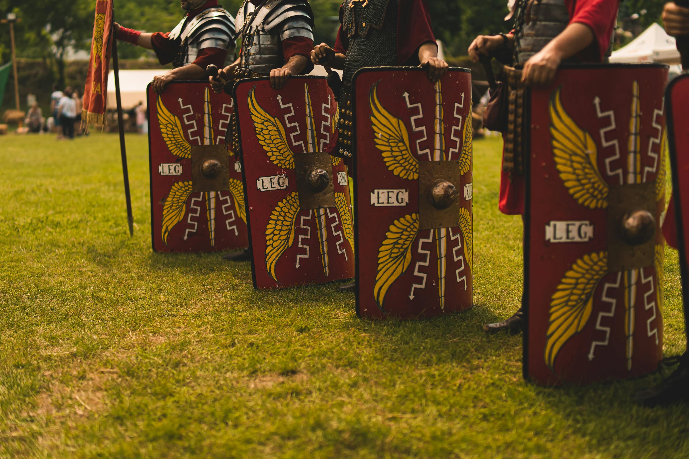 two men dressed up as knights are sitting on shields