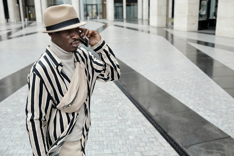 a man on a cellphone is standing in front of a building