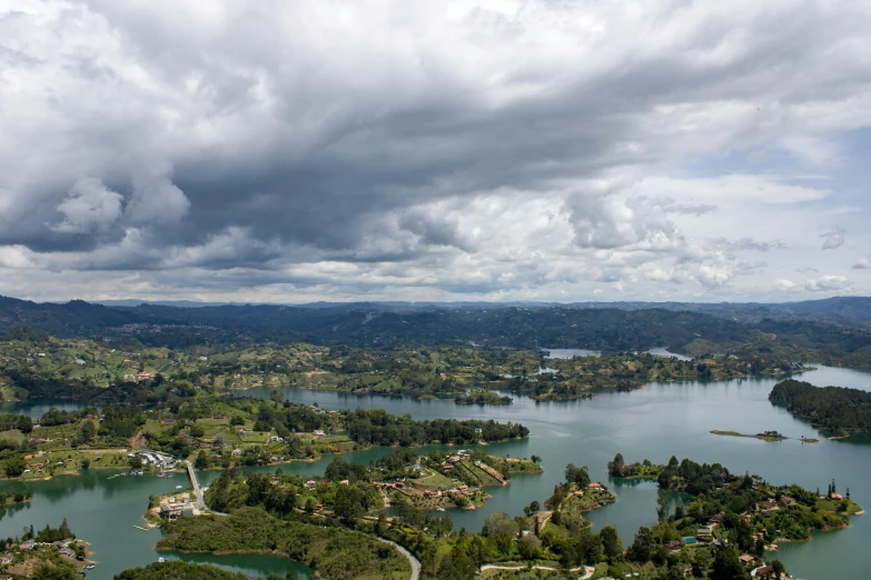 an aerial view of a lake surrounded by green forest