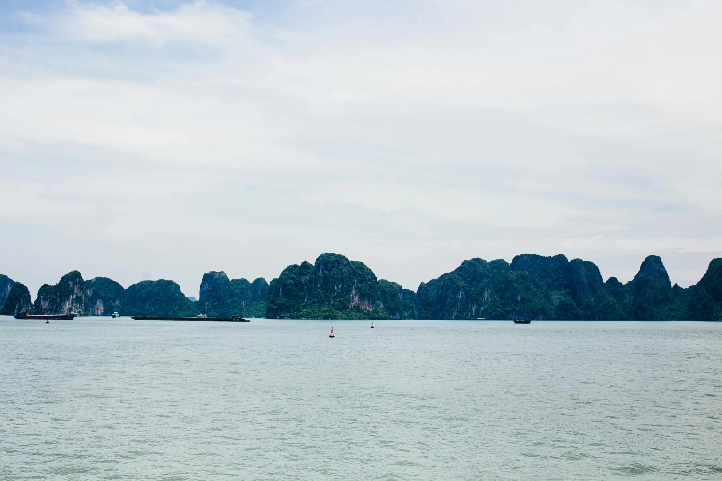 a bunch of small boats in a big body of water