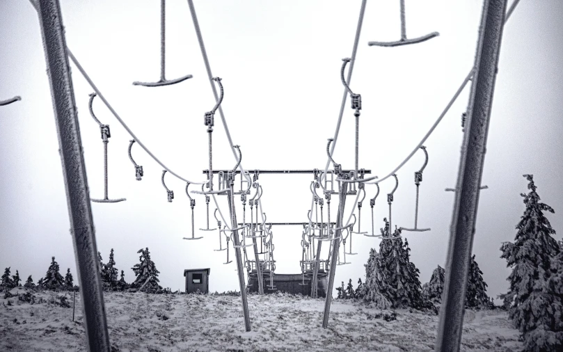 the view of a field from underneath some poles