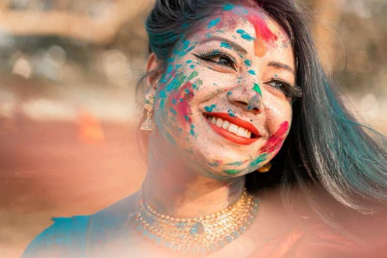 a woman has paint all over her face and smiles