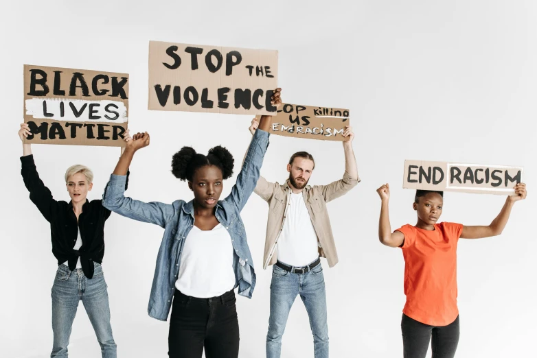 four women hold up protest signs in protest - worthy poses