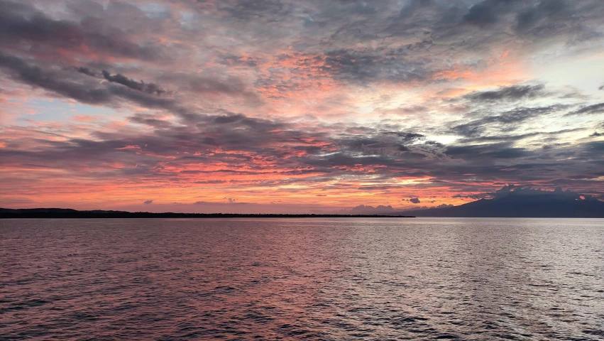 sunset over calm water on an ocean coast