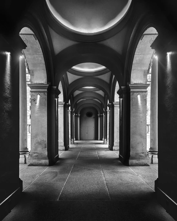 hallway inside an old building in black and white