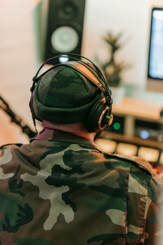 a man wearing headphones is sitting in front of the television