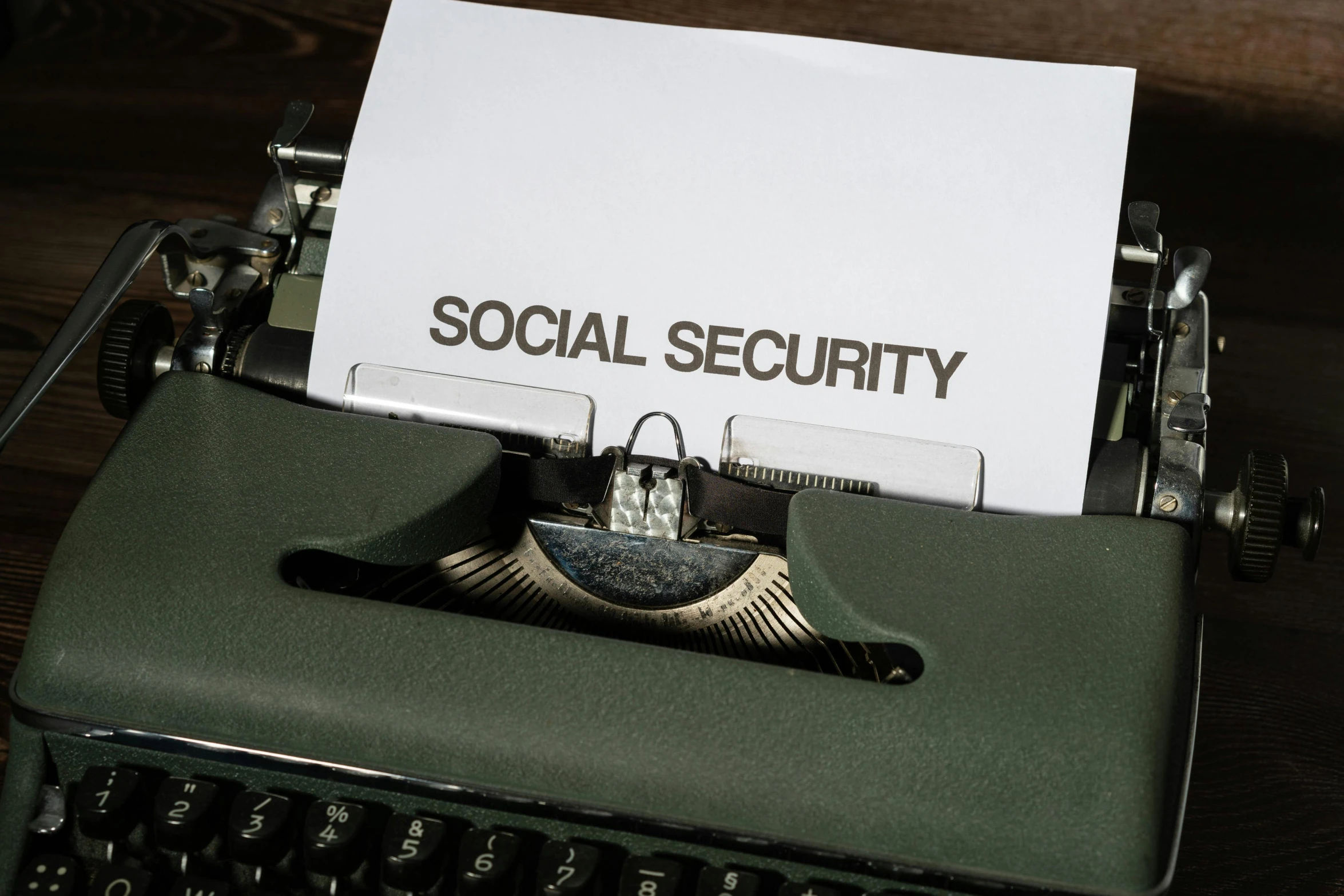 a sign is posted on a typewriter that reads social security