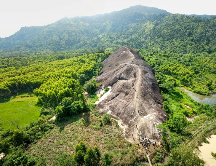 this is an aerial view of a large cliff surrounded by trees and hills