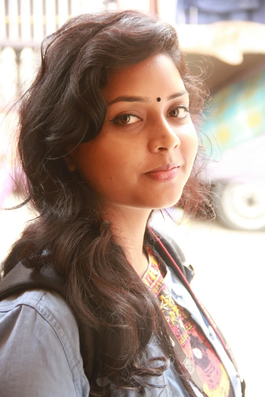 a close up view of a woman in shirt looking away