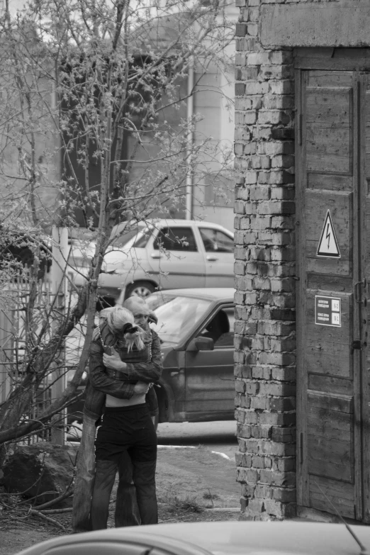 an elderly woman carrying her child on the street