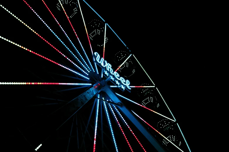 an ornate carnival wheel spins in the sky