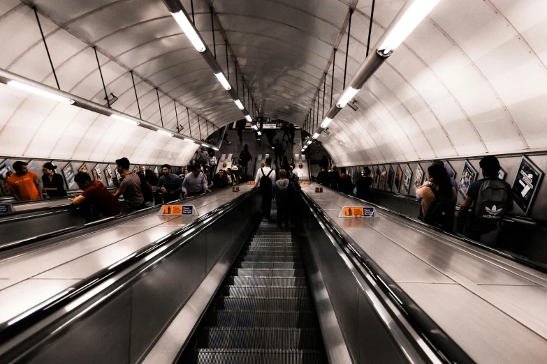 people on escalator in a large metro station