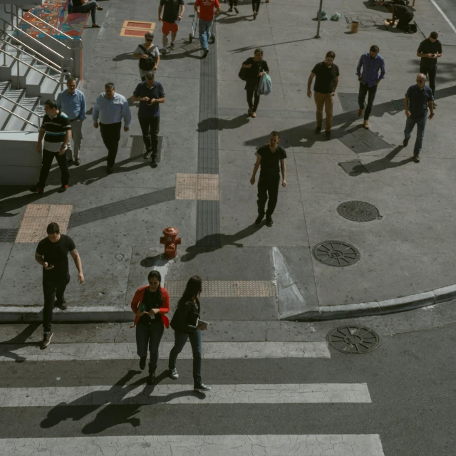 group of people walking across a cross walk